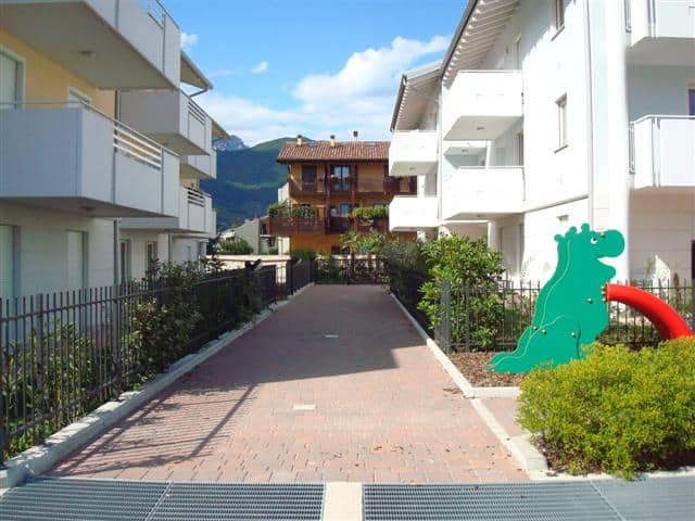 Residenza EOS, edificio moderno con giardini e area pedonale.