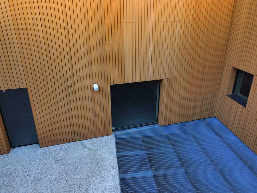 Facciata moderna in legno con ingresso e finestra a Riva del Garda.
