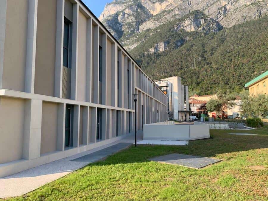 Costruzioni Dallapè Srl edificio moderno con montagne sullo sfondo.